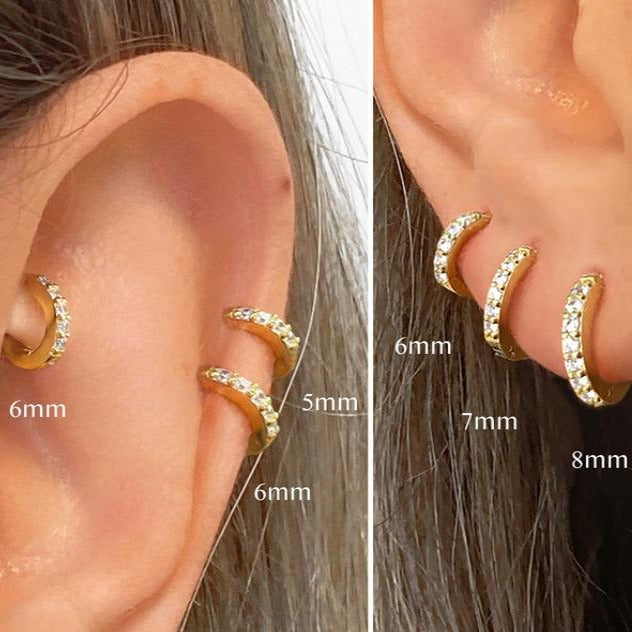 Gold hoop earrings displayed on an ear with size measurements.
