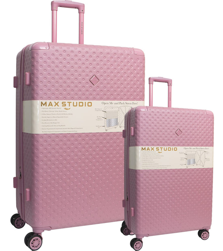 Two pink suitcases with 'MAX STUDIO' label on a white background
