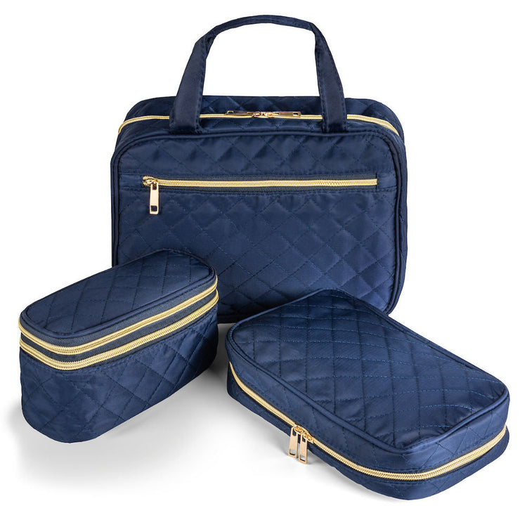 Set of three navy blue travel bags with gold zippers on a white background