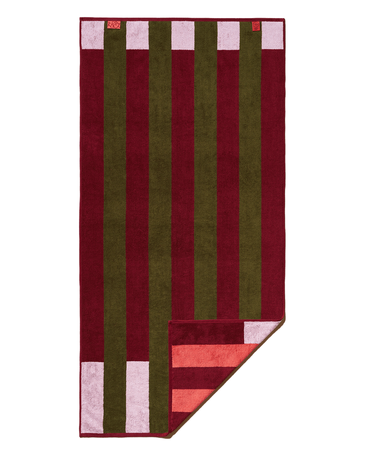 Striped towel with red, green, and pink pattern on a white background