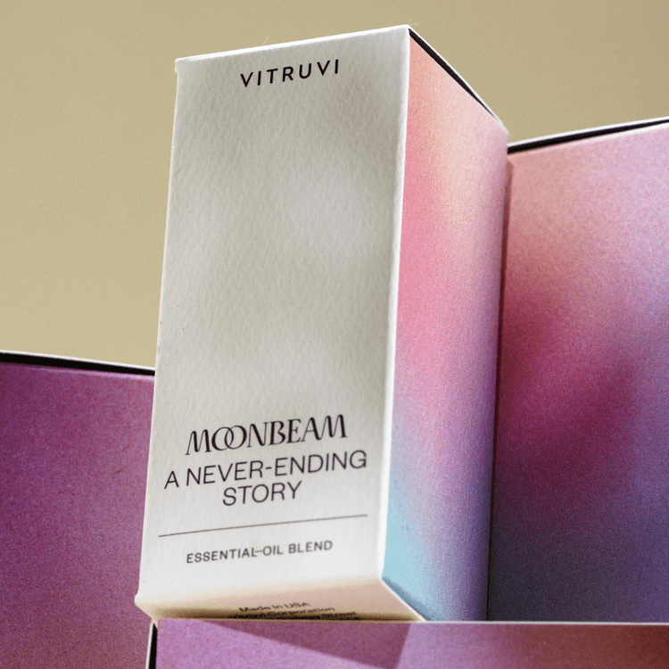 Vitruvi Moonbeam essential oil blend packaging on a gradient background