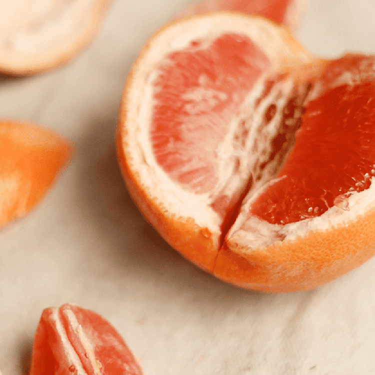 Close-up of sliced grapefruit on a light background