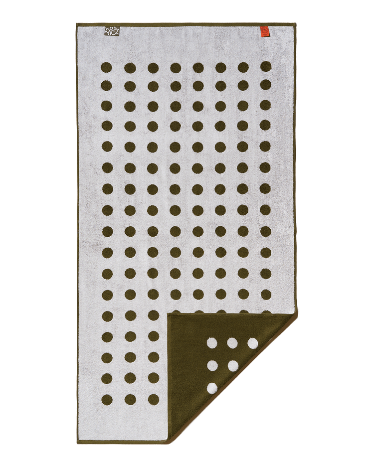 Folded towel with a pattern of brown dots on a white background