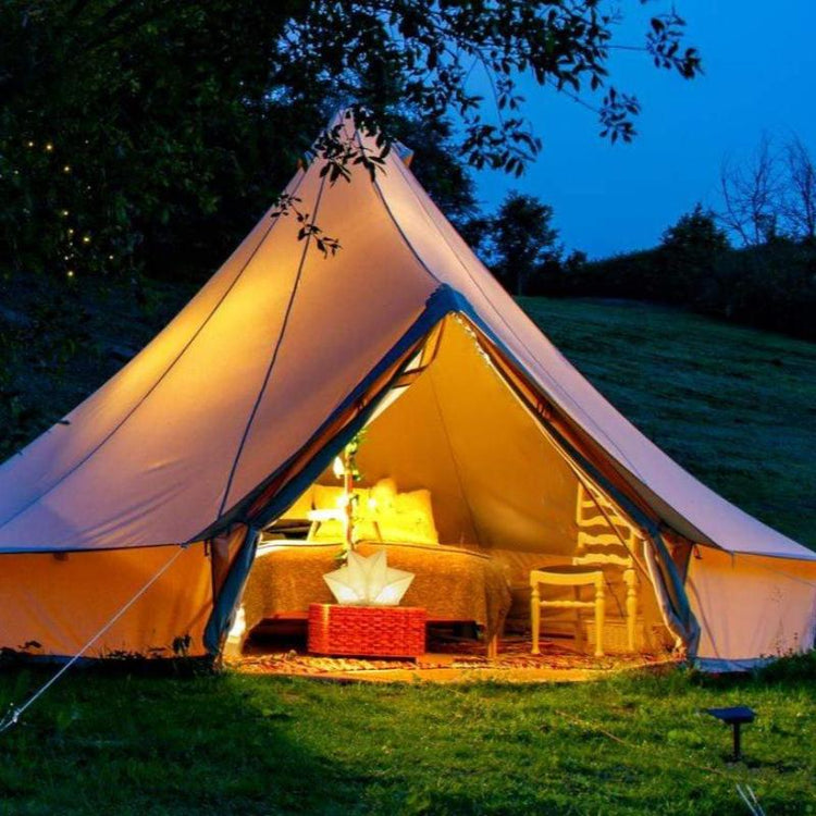 QWNN lantern illuminating interior of glamping tent with warm ambient light