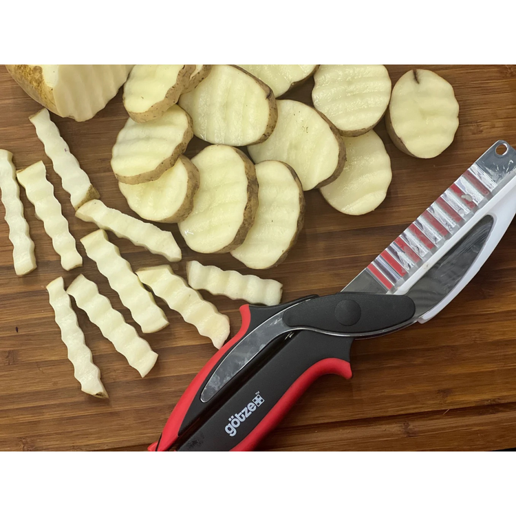 Sliced potatoes and a knife on a wooden cutting board