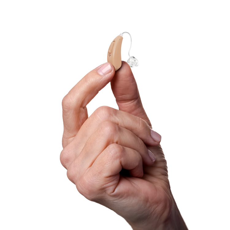 Hand holding a hearing aid against a white background