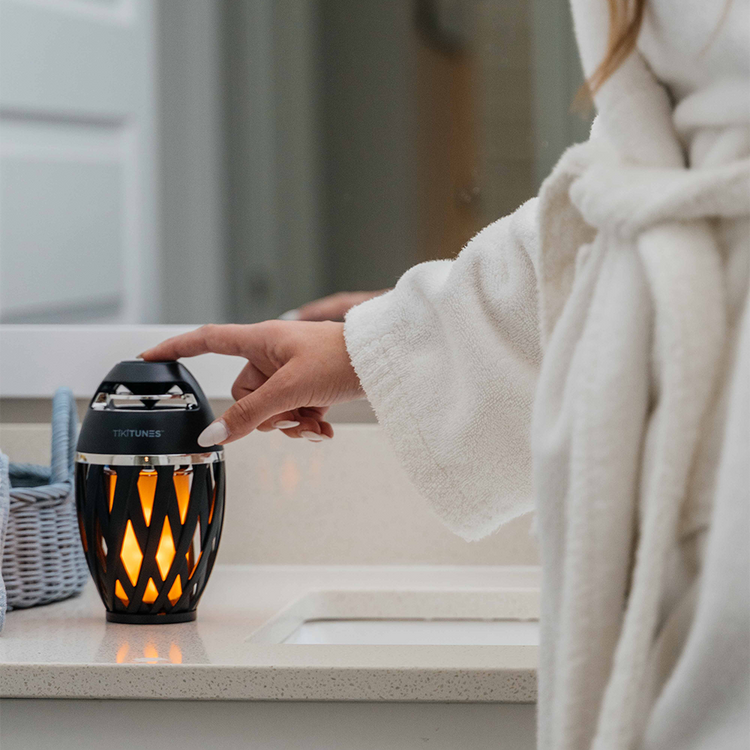 Person in a bathrobe using a Tretorn product on a bathroom counter