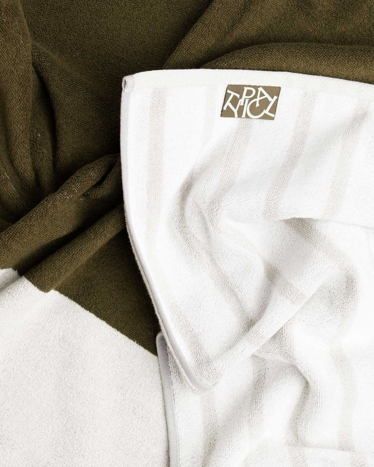 Close-up of a white shirt with a logo on a green fabric background