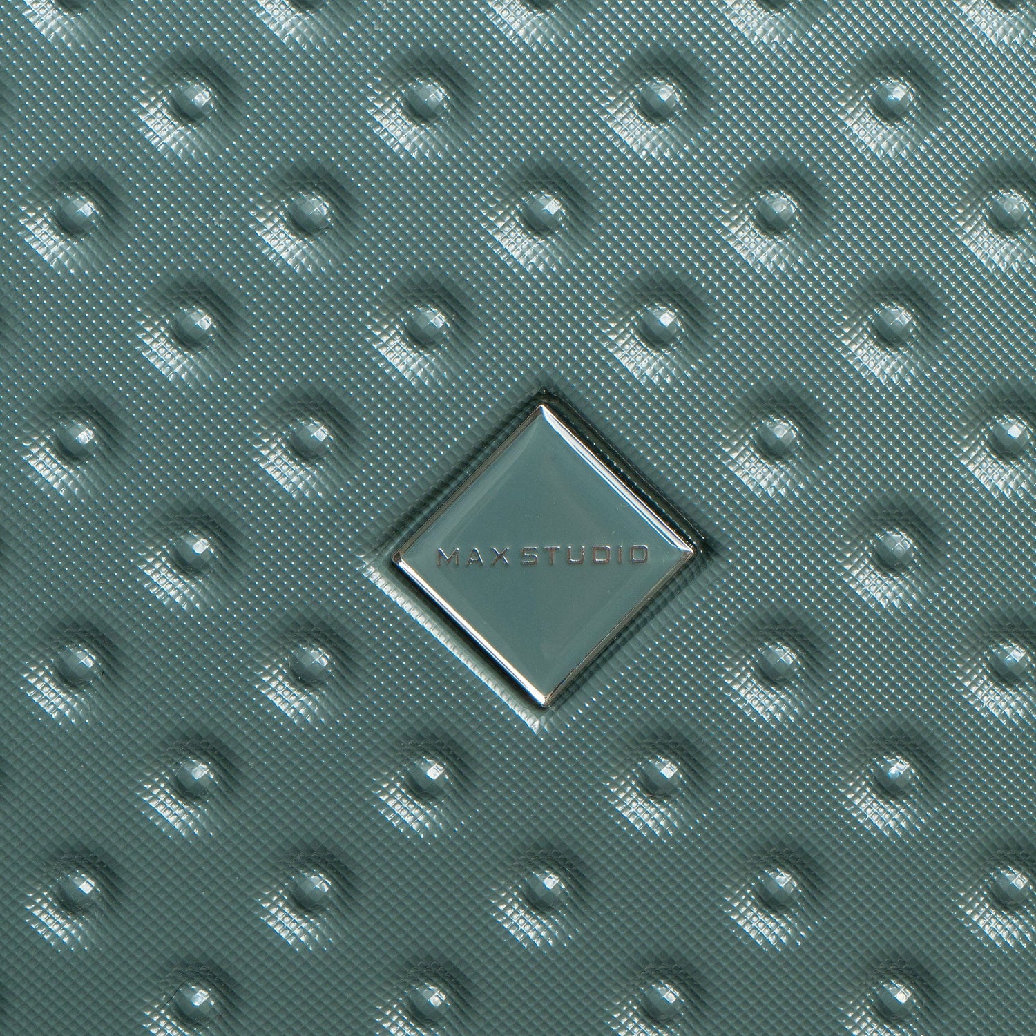 Textured green surface with MAXSTUDIO logo