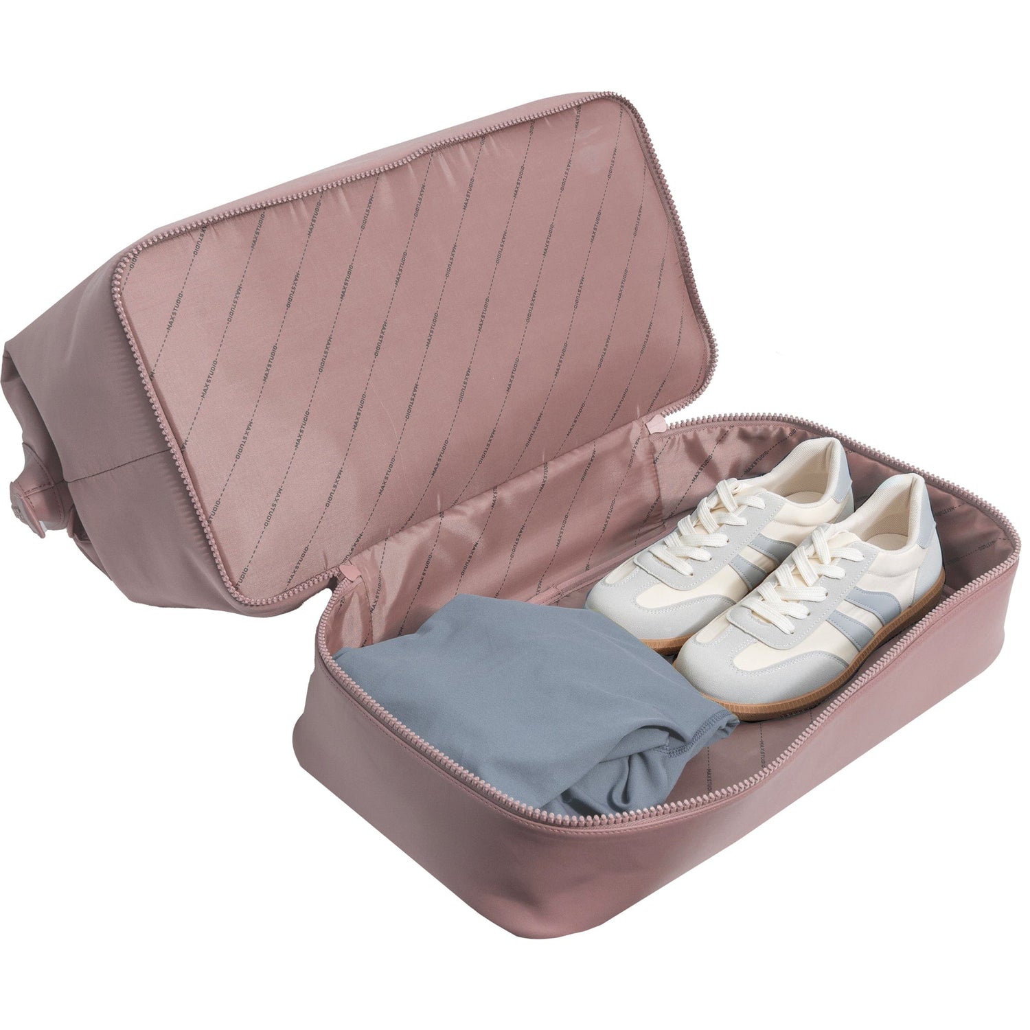 Pink travel shoe organizer with a white sneaker and gray cloth inside on a white background