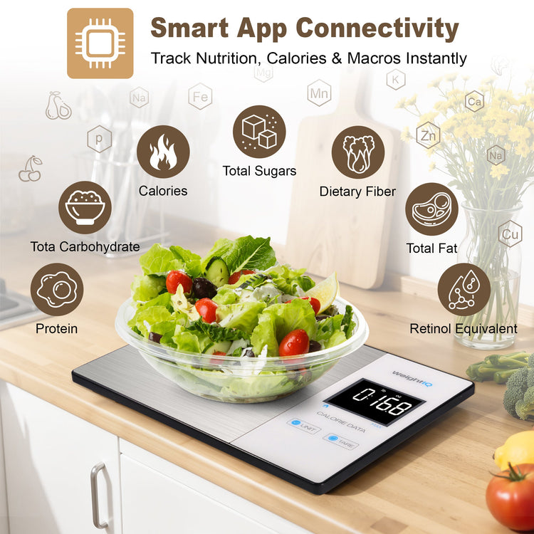 Smart kitchen scale with digital display on a kitchen counter, surrounded by vegetables and a salad bowl.