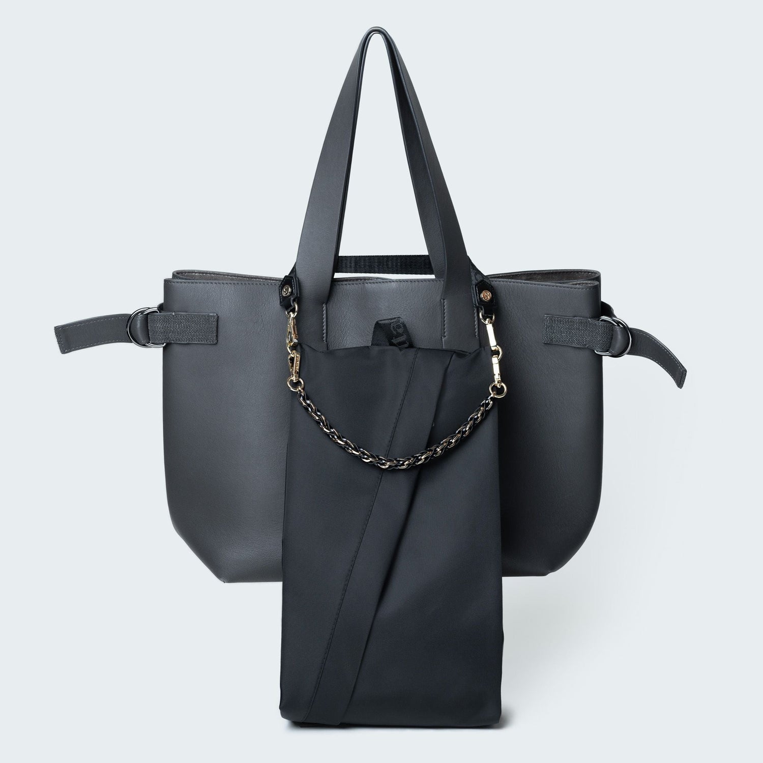 Black handbag with a chain detail on a light gray background