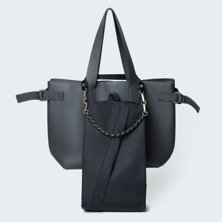 Black handbag with a chain detail on a light gray background