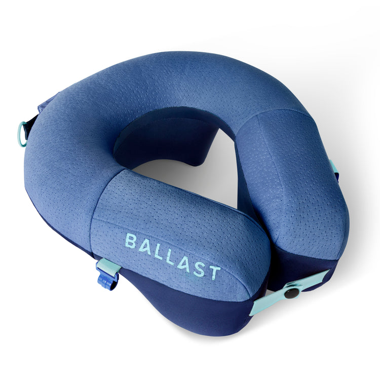 Blue travel neck pillow with 'BALLAST' branding on a white background