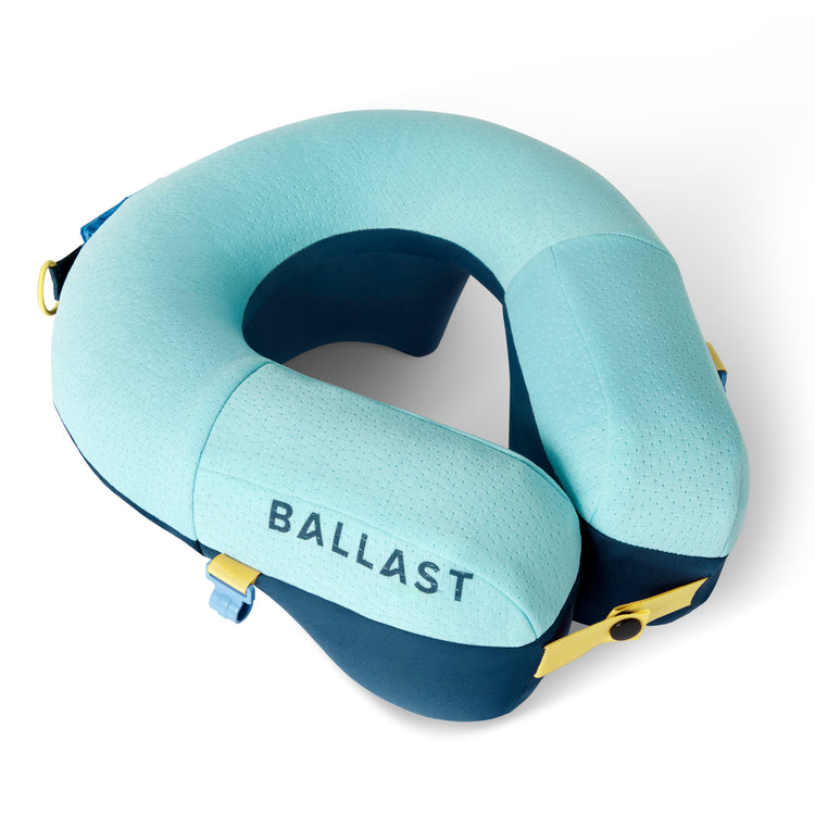 Light blue and navy travel neck pillow with 'BALLAST' branding on a white background