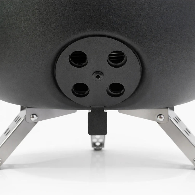 Close-up of a black outdoor fire pit with metal legs on a white background