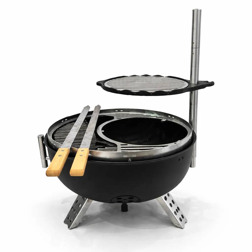 Portable grill with two grilling plates and tongs on a white background