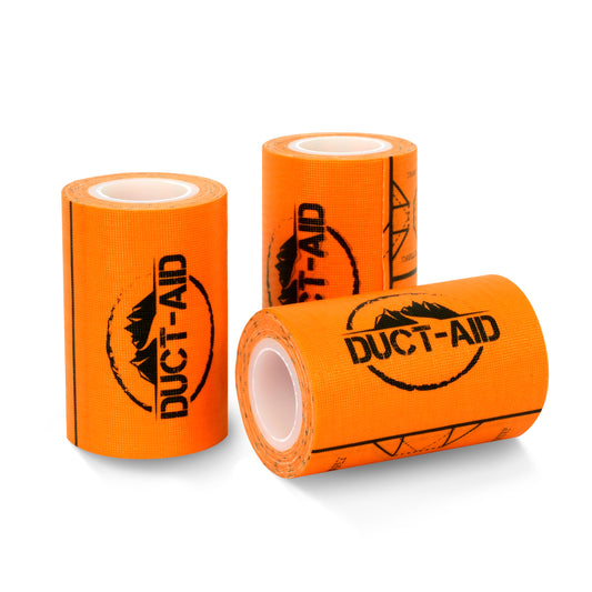 Three rolls of bright orange DUCT-AID tape with black printed branding, arranged on a clean white background.