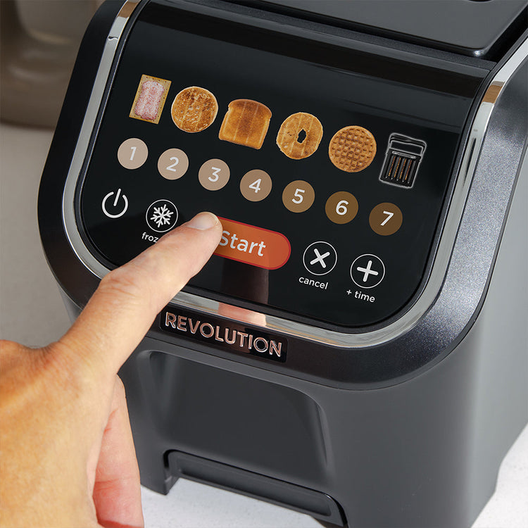Hand pressing a button on a kitchen appliance with digital display and 'Revolution' branding.