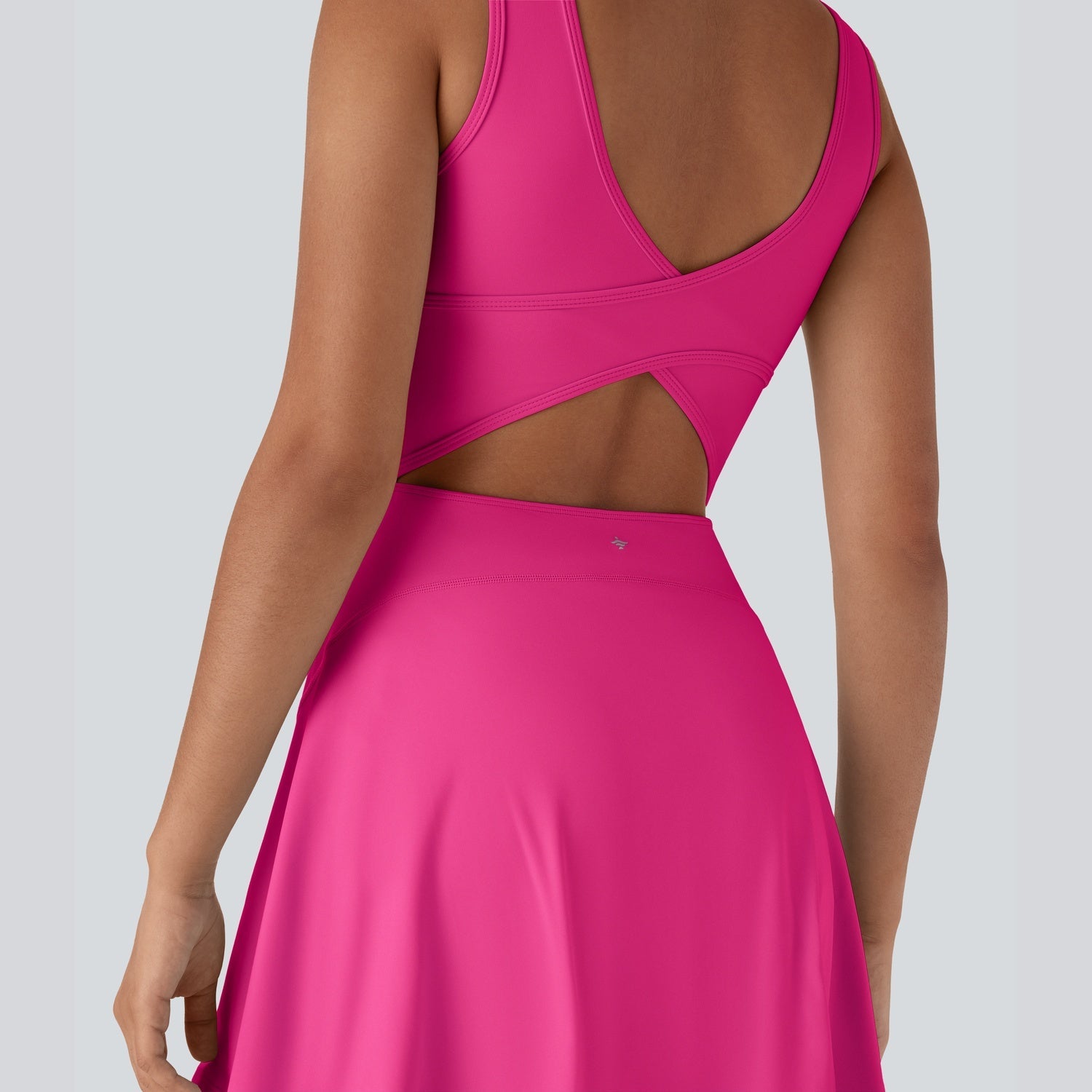 Pink dress with open back on a plain background