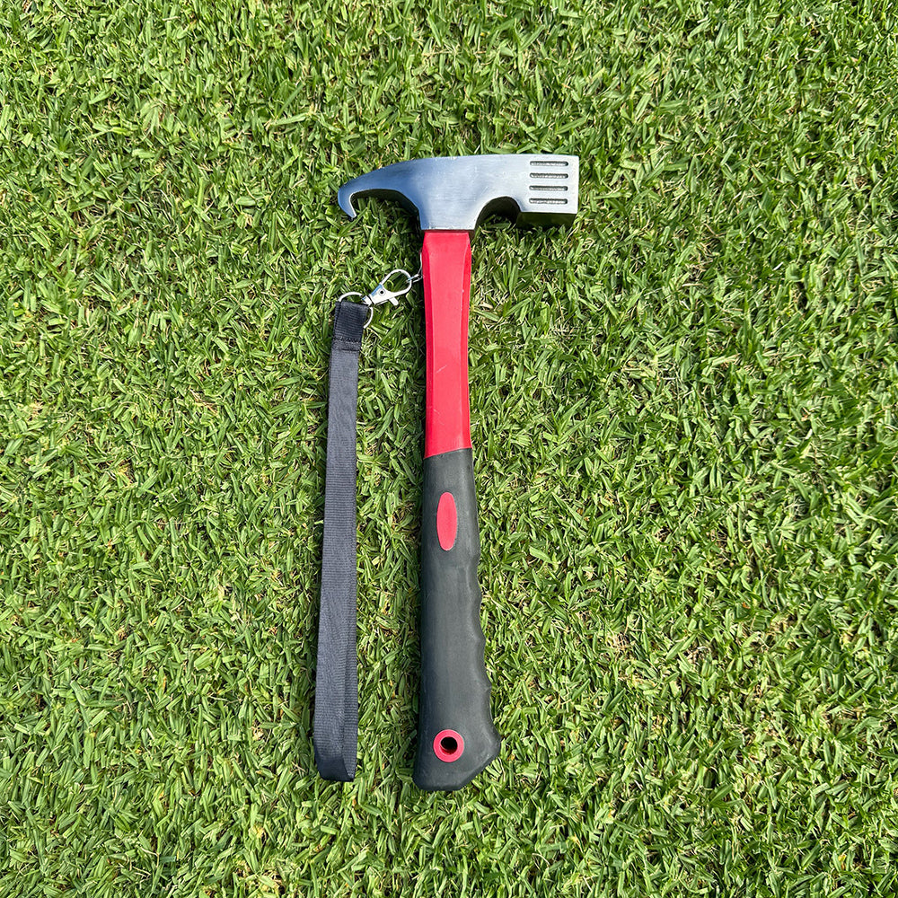 Four red tent stakes on a grassy surface