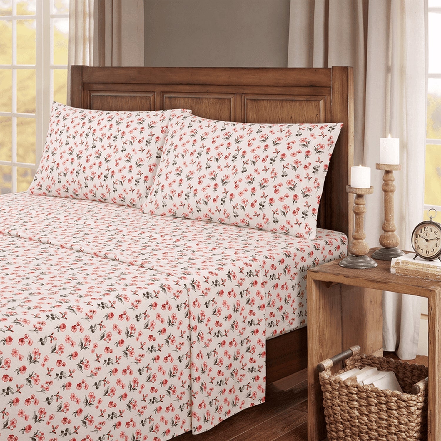 Floral bedspread on a bed with a wooden headboard and nightstand in a bedroom setting.