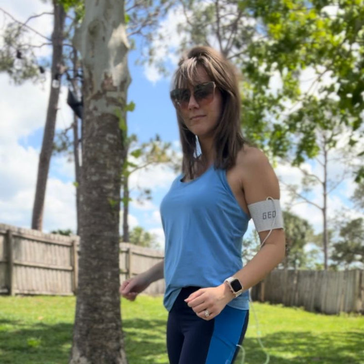 Woman in blue athletic wear with a heart rate monitor outdoors