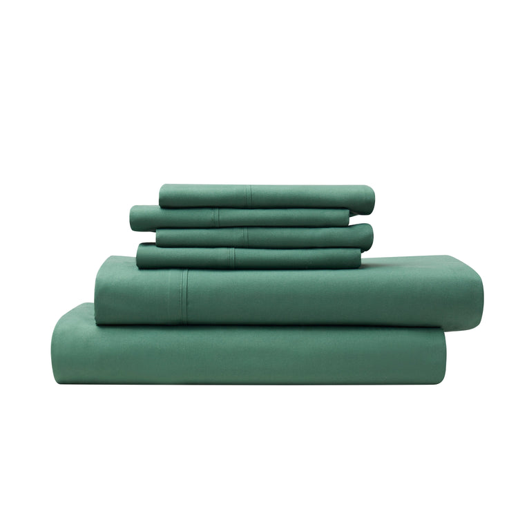 Set of green bedding sheets and pillowcases on a white background