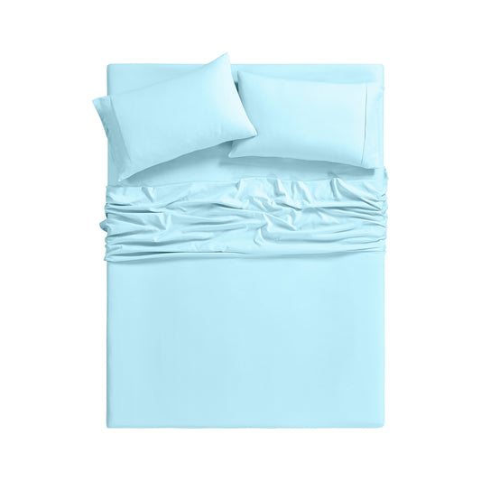 Light blue bedding set on a bed in a room with large windows.