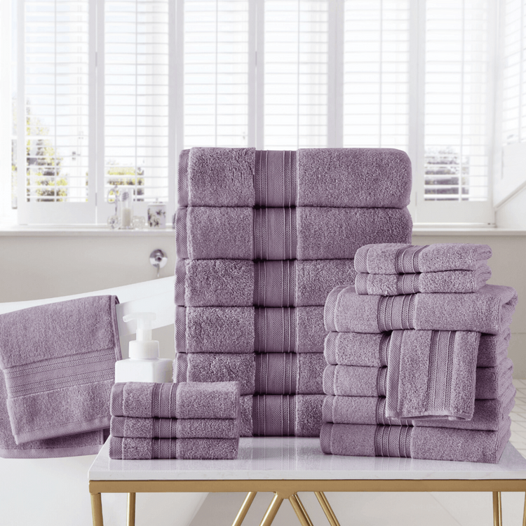 Stack of purple towels on a table with a window in the background