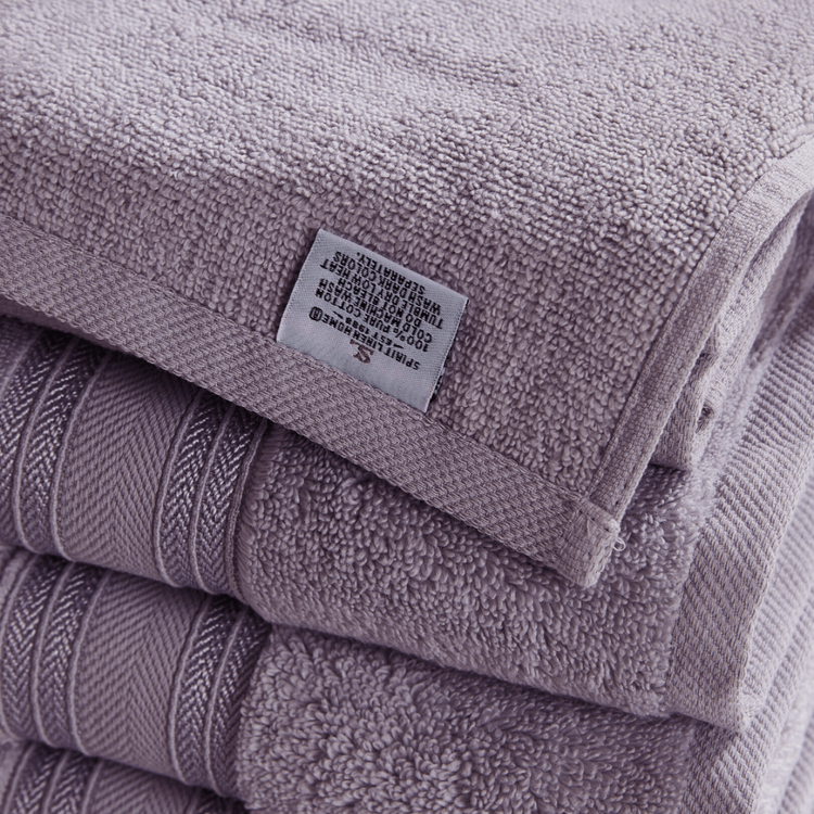 Stack of purple towels with a label on top