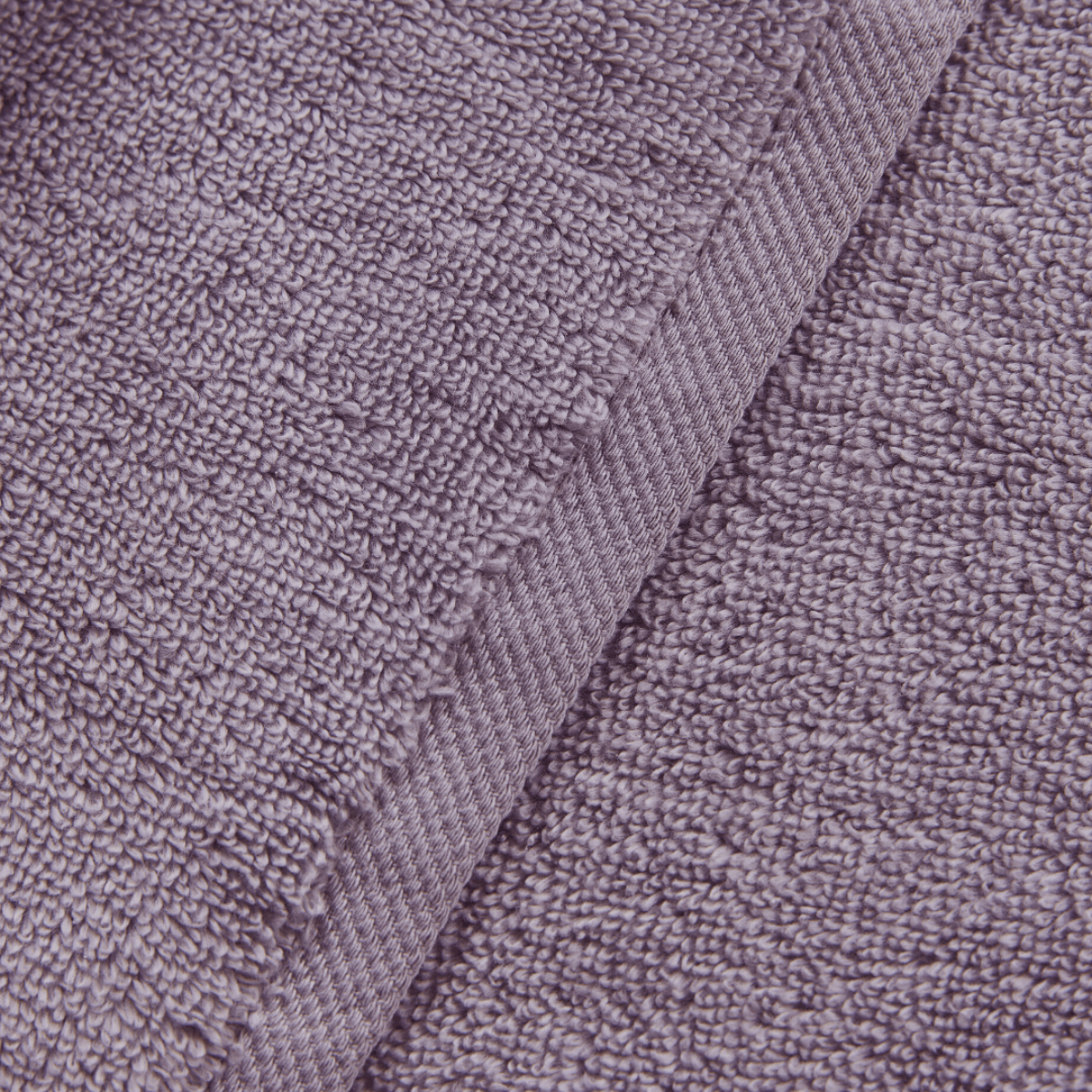 Close-up of a textured purple fabric with a subtle pattern
