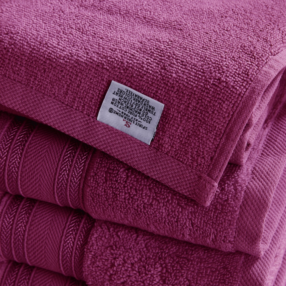 Stack of pink towels with a label on top