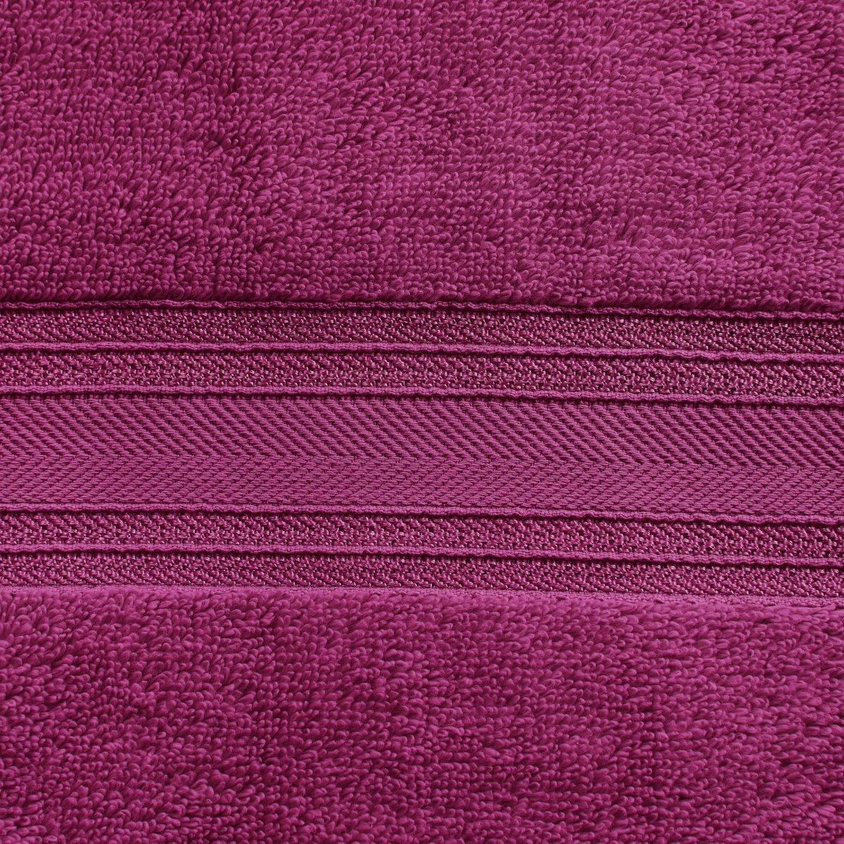 Close-up of a purple zipper on a textured purple fabric background