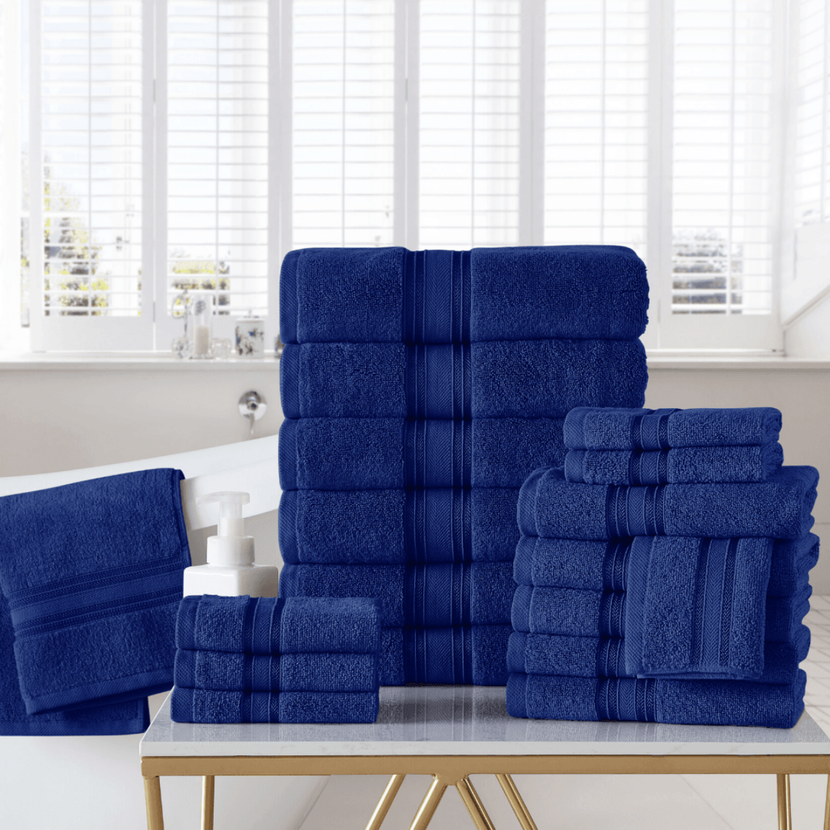 Set of blue towels on a table with a window in the background