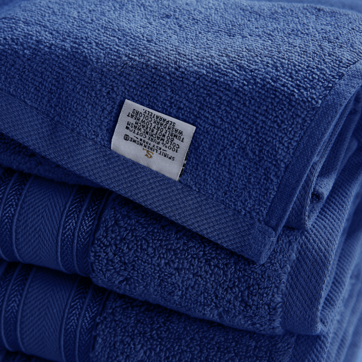 Stack of blue towels with a label on a white background