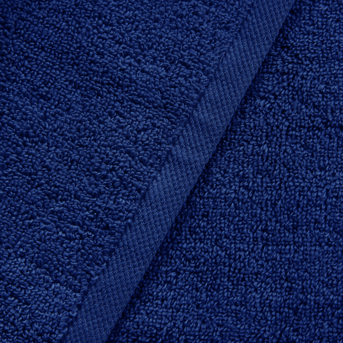 Close-up of blue textured fabric with a visible seam.