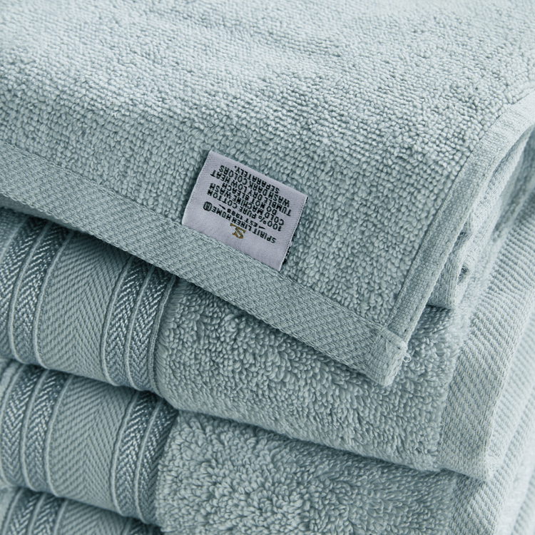 Stack of light blue towels with a label on top