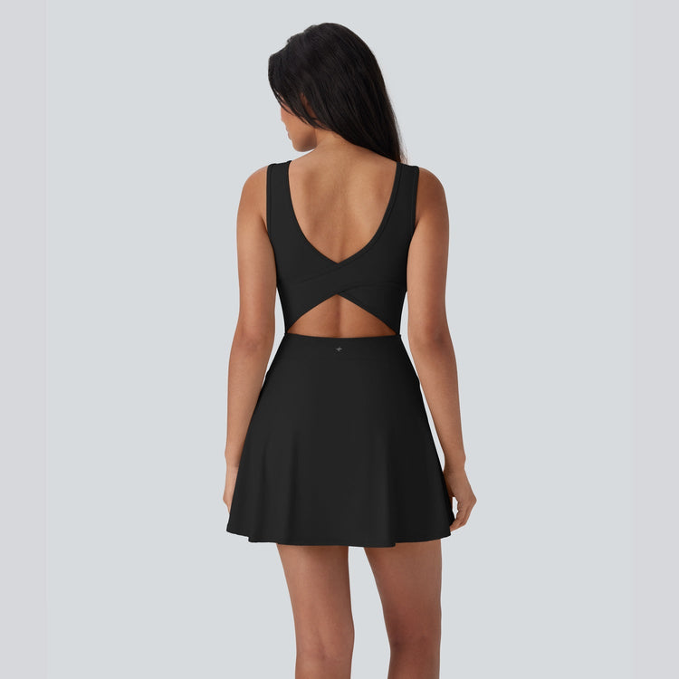 Black dress with cutout back on a plain background