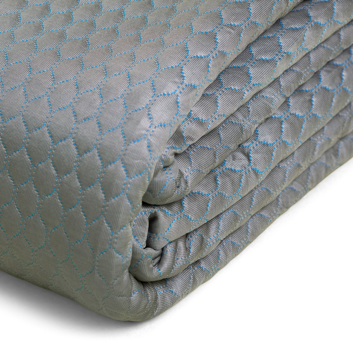 Folded quilt with geometric pattern on a white background