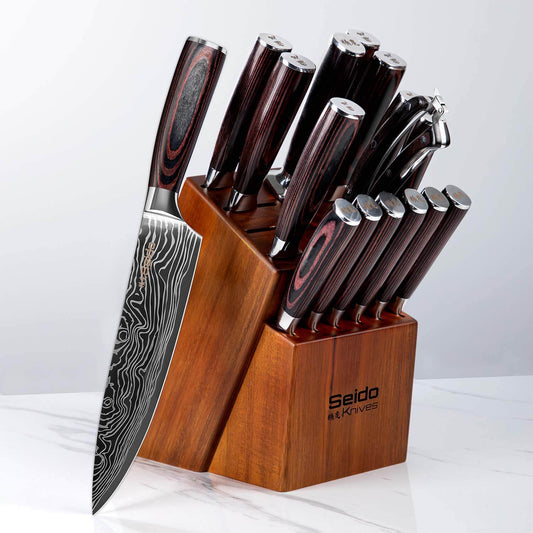 Set of knives with wooden block on a white background
