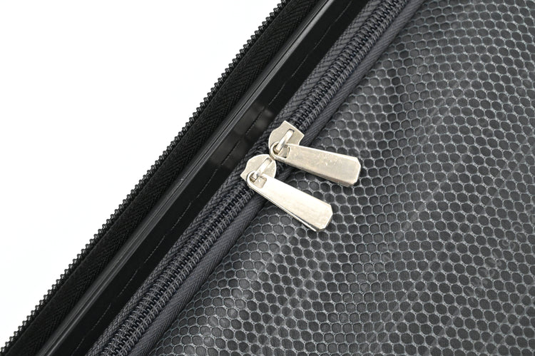 Close-up of a black textured surface with a zipper and silver zipper pull.