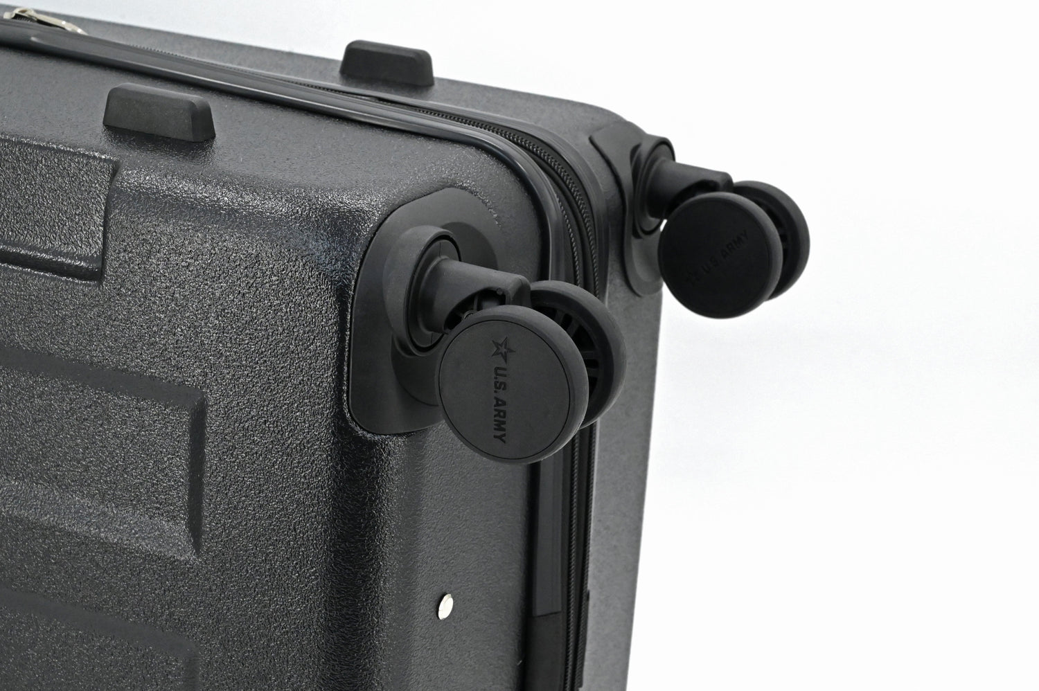 Close-up of a black suitcase with wheels on a white background