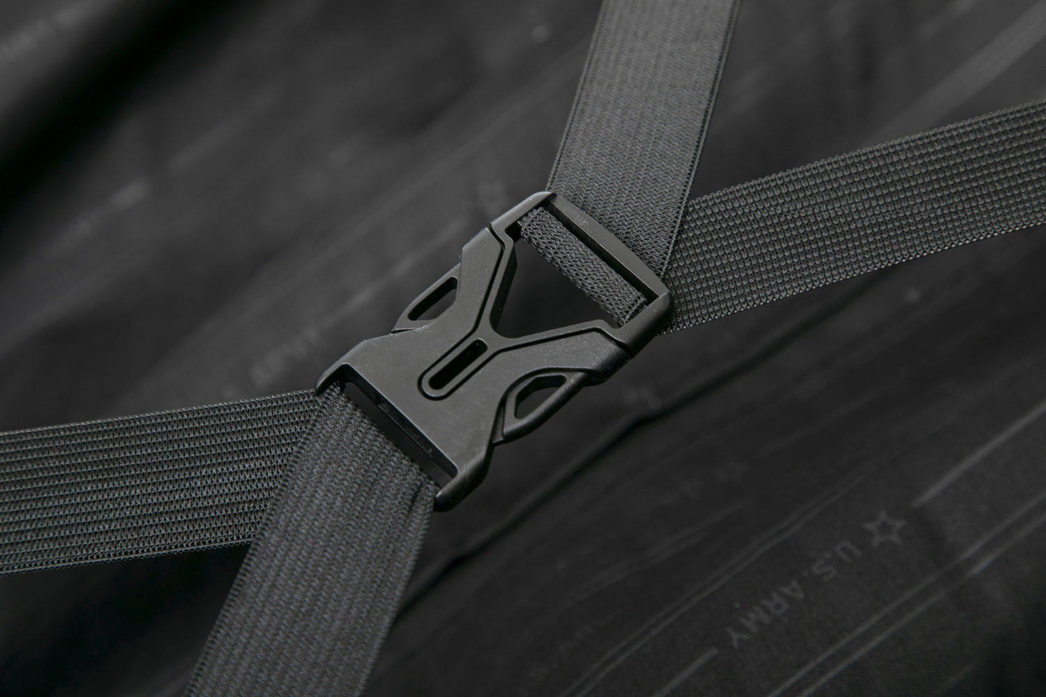 Close-up of a black seat belt buckle on a dark wooden surface