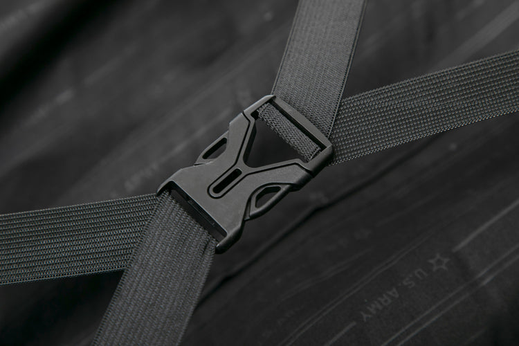 Close-up of a black seat belt buckle on a dark wooden surface