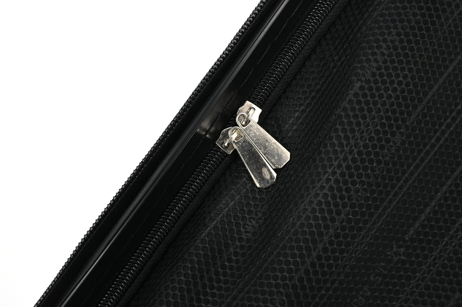 Close-up of a black suitcase with a silver zipper pull on a white background