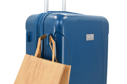 Set of three blue suitcases with wheels on a white background
