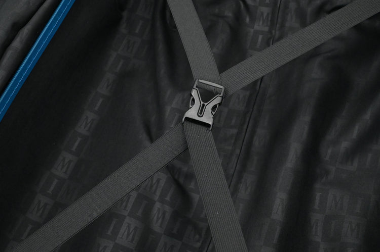 Close-up of a black bag with straps and a visible brand logo.