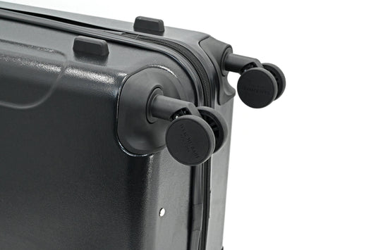 Set of three blue suitcases with wheels on a white background