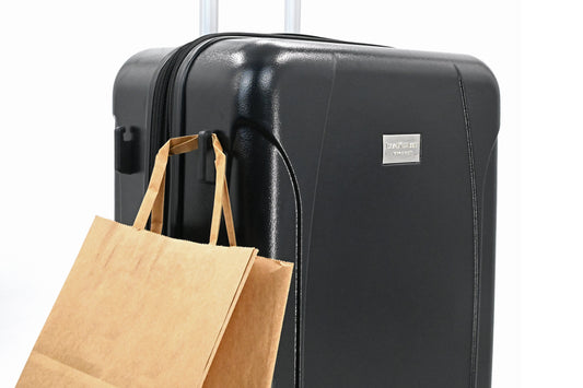 Set of three blue suitcases with wheels on a white background